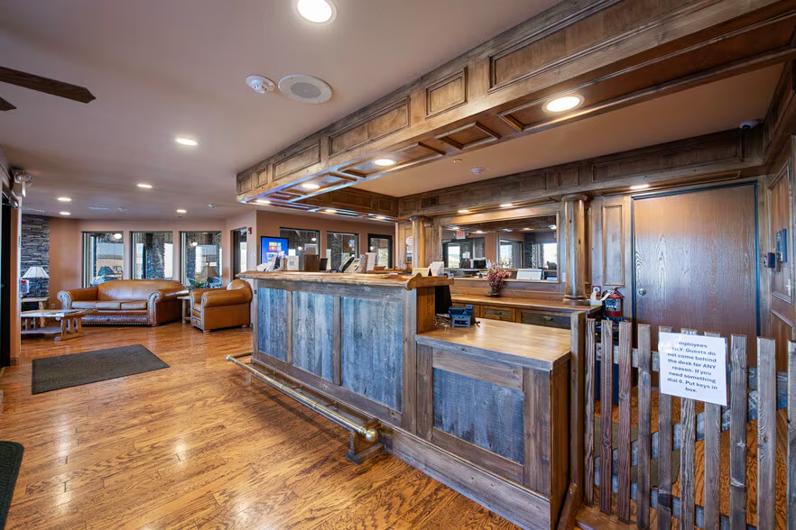 Front desk and reception with warm wood paneling